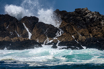 Waves crashing against rocks on a windy day
