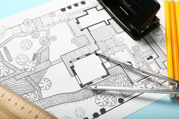 Landscape designer's plan with stationery on color background, closeup