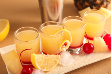 Plate with tasty Pineapple Upside Down Cake Shots on beige background