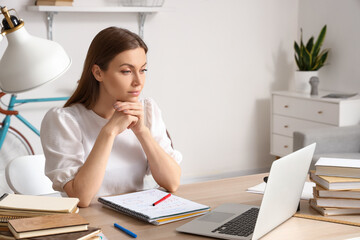 Student video chatting with tutor online at home