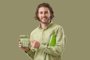 Handsome man with calculator and notebooks on green background - obrazy, fototapety, plakaty