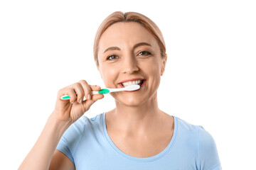 Beautiful mature woman brushing teeth on white background