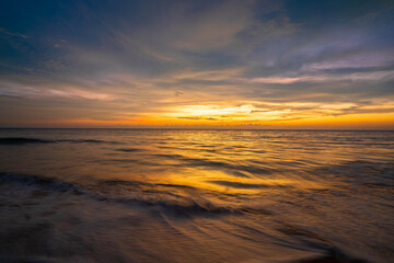 Fototapeta na wymiar beautiful sunset and orange sky by the sea