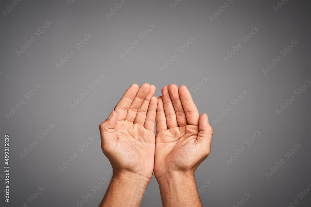 Poster life is all about give and take. studio shot of unidentifiable hands cupped against a gray backgroun