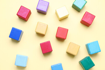 Wooden cubes on yellow background