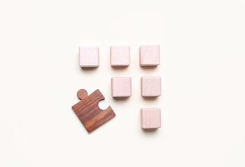 Wooden cubes with letters and puzzle piece on white background