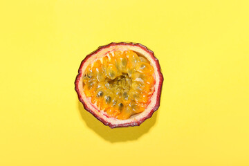 Delicious cut passion fruit on yellow background