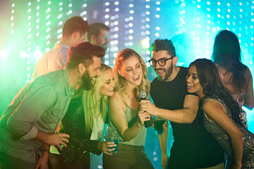 Theres a superstar in all of us. Shot of a group of friends singing karaoke at a party. - obrazy, fototapety, plakaty