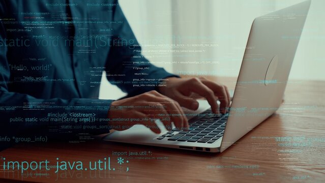 Computer programmer uses capable laptop computer to develop programming code of new software . Computer specialist working on future coding application for software programming development .