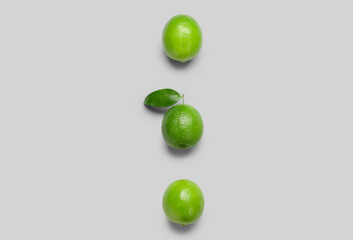 Fresh juicy limes on light background