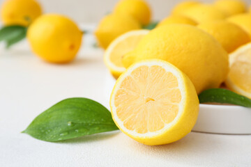 Many fresh lemons on light table, closeup
