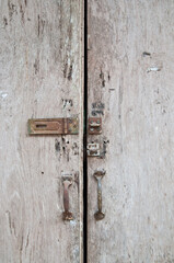 Unlocked wooden grey dirty door panes closed down