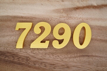Golden Arabic numerals on a real brown and white wooden floor number 7290