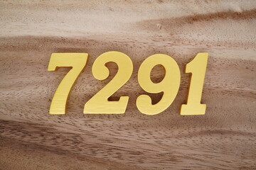 Golden Arabic numerals on a real brown and white wooden floor number 7291