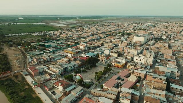 Aerial shot at sunset of the square and city of Tumbes, Peru
