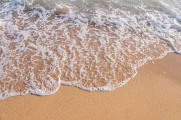 Soft wave of the sea on the sandy beach.
