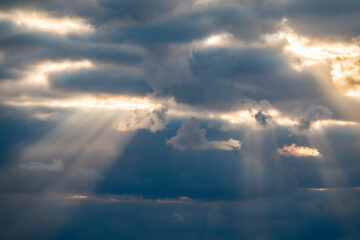 Naklejka na ściany i meble Dramatic sky with sunbeams through the clouds
