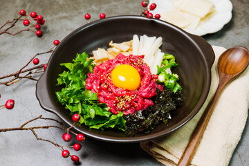 Yukhoebibimbap, Korean style Beef Tartare Bibimbap : This is a bowl of rice topped with seasonal namul (seasoned vegetables) and fresh yukhoe (chopped raw beef) and served with seasoning. Lean fresh r
