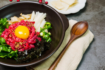 Yukhoebibimbap, Korean style Beef Tartare Bibimbap : This is a bowl of rice topped with seasonal namul (seasoned vegetables) and fresh yukhoe (chopped raw beef) and served with seasoning. Lean fresh r