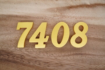 Golden Arabic numerals on a real brown and white wooden floor number 7408