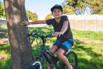 Naklejka premium Wanna ride. Cropped portrait of a young boy riding his bike outside.