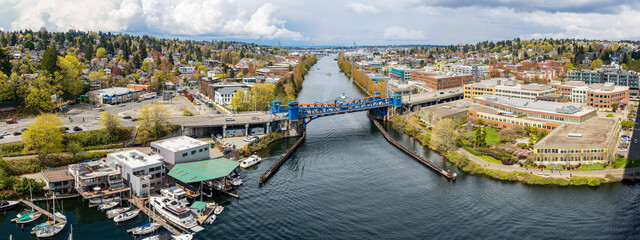 A panorama of the blue Fremont Bridge spans the Fremont cut
