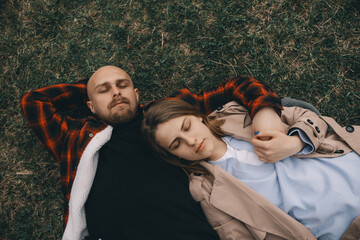 young couple laying on grass. summer love