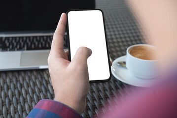 Cell phone blank white screen mockup. Man hands holding, using mobile phone at office background, template for advertisement