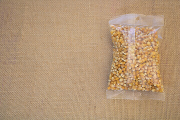 Close up shot of packed dry popcorn on burlap background with copy space