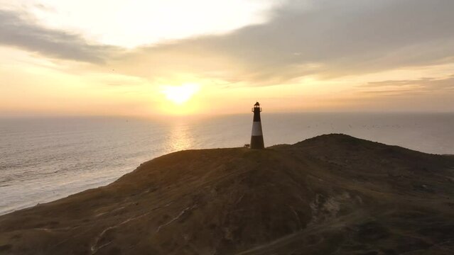 Magical sunset in a lighthouse, the cliffs with sea birds. Puerto Eten at sunset, Lambayeque, Peru
