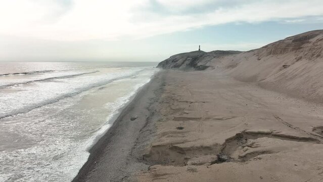 Aerial view of Media Luna Beach and lighthouse, Puerto Eten, Lambayeque, Peru.