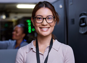 Trust me, your severs are in good hands. Cropped portrait of an attractive young female programmer working in a server room with her colleague in the background. - Powered by Adobe