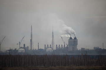 Fototapeta na wymiar cogeneration power plant emits a lot of smoke and steam in a residential area. High quality photo