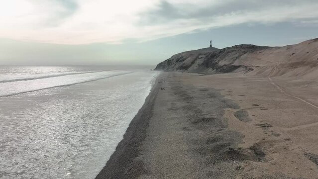 Aerial view of Media Luna Beach and lighthouse, Puerto Eten, Lambayeque, Peru.