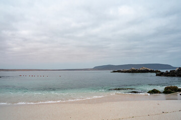 Horizontal view of turquoise beach on cloudy day