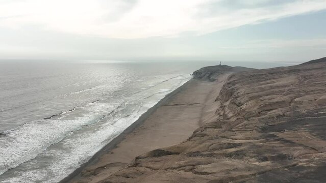 Aerial view of Media Luna Beach and lighthouse, Puerto Eten, Lambayeque, Peru.