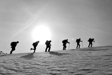 group of mountaineers moving in harmony towards the summit of the mountains