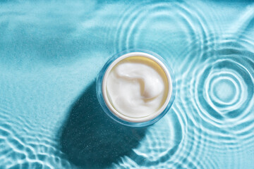beauty cream on blue water surface