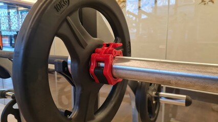 barbell weight disc with plastic barbell lock in gym