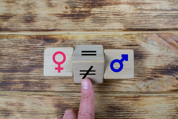  wooden cube with unequal symbol changing to equal sign