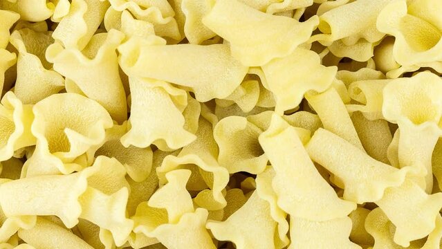 Closeup of uncooked italian pasta - campanelle, pasta background