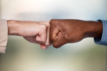 Pump up your business with the power of partnership. Shot of two unrecognisable businesspeople bumping fists.