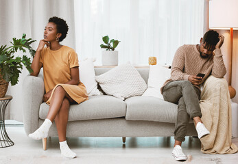 Hes always on his phone. Shot of a young couple having an argument at home.