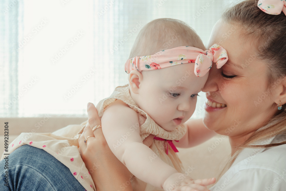 Wall mural Loving happy mum carrying of newborn baby at home