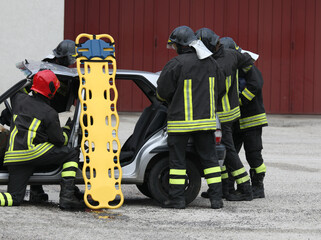 firefighters during the rescue operations of the injured with the stretcher for transport to the...
