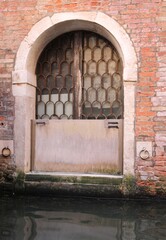 Mobile gate in stainless steel for the protection of the door during high tide in Venice