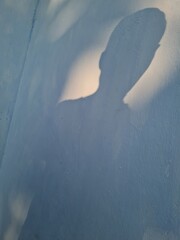 Abstract background of boy shadow on building wall in blue paint color