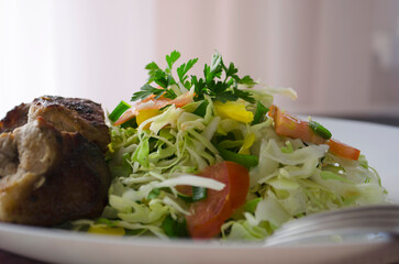 Fresh salad, barbecue, skewers on skewers with potato chips, lettuce and fresh homemade cucumbers.