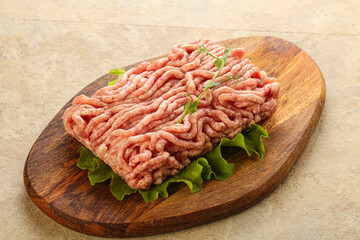 Raw minced pork meat over board