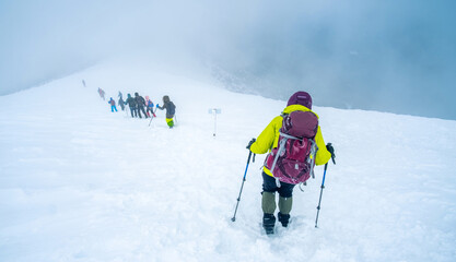 Tourist group descending after conquering winter mountain